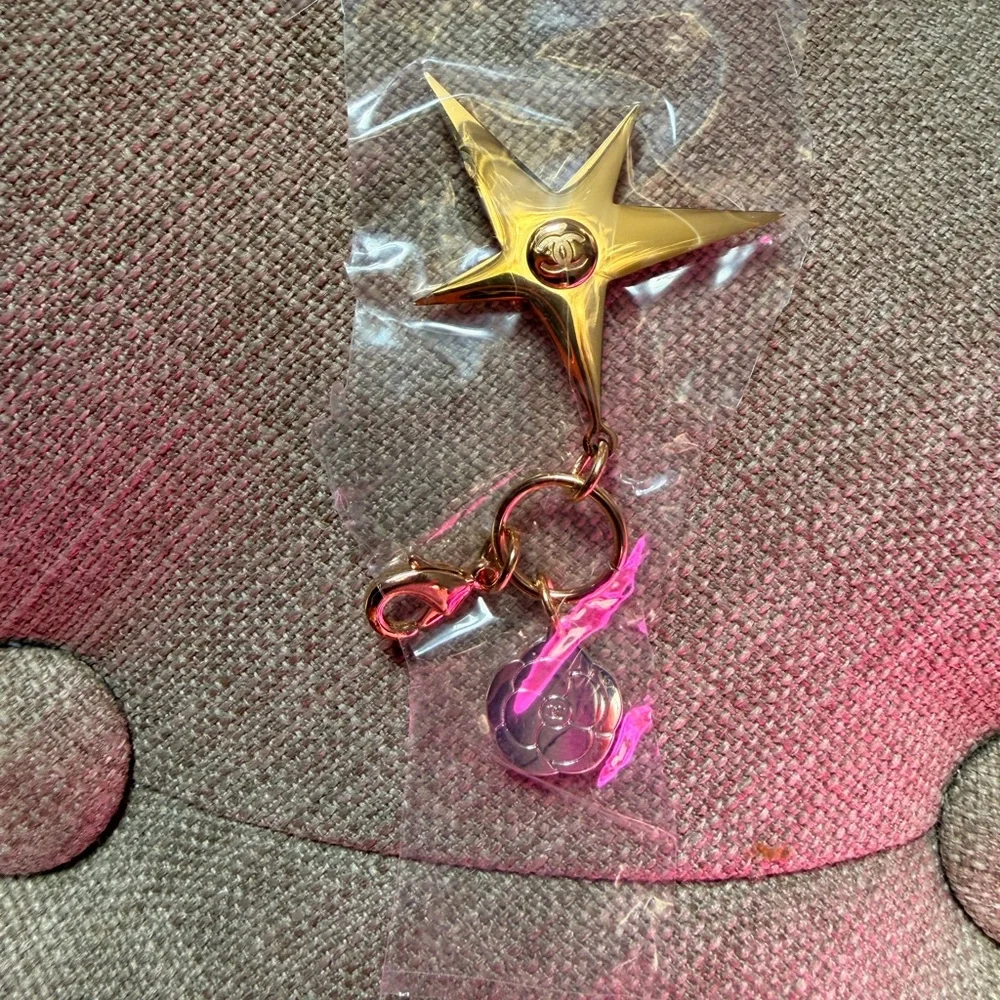 NWOT Authentic CHANEL Gold Star and Silver Camellia Flower Charm.